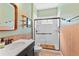 Beautiful bathroom featuring a glass enclosed shower, modern sink, stylish mirror, and sleek fixtures at 4811 Forest Creek Trl, Parrish, FL 34219