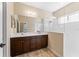 Bathroom featuring double sink vanity and glass-enclosed shower at 4811 Forest Creek Trl, Parrish, FL 34219