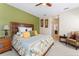 View of bedroom including bed with decorative pillows, side tables, and doorway to a bathroom at 4811 Forest Creek Trl, Parrish, FL 34219