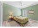 Stylish bedroom featuring wood floors, patterned comforter and decor at 4811 Forest Creek Trl, Parrish, FL 34219