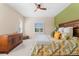 Bedroom with green accent wall and a plush bed with patterned bedding at 4811 Forest Creek Trl, Parrish, FL 34219