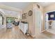 Hallway with wood-look tile flooring, flowing into the living space and offering access to the powder room at 4811 Forest Creek Trl, Parrish, FL 34219