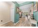 Spacious hallway with wood-look tile flooring leading into the living area, creating a seamless transition at 4811 Forest Creek Trl, Parrish, FL 34219