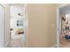 Hallway view into bedroom with fan and bathroom beyond at 4811 Forest Creek Trl, Parrish, FL 34219