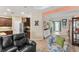 Open-concept living space connecting kitchen, dining, and entryway, with tile flooring throughout at 4811 Forest Creek Trl, Parrish, FL 34219