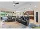 Bright living room with wood-look tile flooring, open to kitchen and featuring modern furnishings at 4811 Forest Creek Trl, Parrish, FL 34219