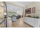 Open-concept living space with wood-look tile floors, flowing into the kitchen and seating area at 4811 Forest Creek Trl, Parrish, FL 34219