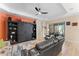Spacious living room featuring stylish ceiling fan and custom built-in shelving for decorative storage at 4811 Forest Creek Trl, Parrish, FL 34219