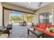 Screened patio with comfortable seating and a view of the pool and tropical landscaping at 4811 Forest Creek Trl, Parrish, FL 34219