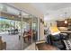 Open living space transitions to patio through sliding glass doors to outdoor dining and pool area at 4811 Forest Creek Trl, Parrish, FL 34219