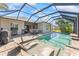 Inviting pool with beach entry, screened enclosure, and outdoor seating perfect for relaxation and entertaining at 4811 Forest Creek Trl, Parrish, FL 34219