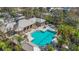A pristine community pool features covered lounge area, jacuzzi, and ample deck space at 4811 Forest Creek Trl, Parrish, FL 34219