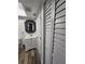 Bathroom view with wood-look floors, modern vanity, decorative mirror, and shuttered closet at 500 New York Ave # 21, Dunedin, FL 34698