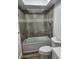 Bathroom features a tiled shower-over-tub combination with glass enclosure and decorative trim at 500 New York Ave # 21, Dunedin, FL 34698