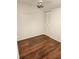 Bedroom showcases a ceiling fan, closet with louvered doors, and wood-look flooring at 500 New York Ave # 21, Dunedin, FL 34698