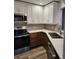 Modern kitchen features stainless steel appliances, white cabinetry, and gorgeous countertops at 500 New York Ave # 21, Dunedin, FL 34698