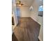 Spacious living room with vaulted ceilings, ceiling fan, and hardwood floors at 500 New York Ave # 21, Dunedin, FL 34698