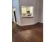 Open-concept living room showcasing new hardwood floors, with kitchen pass-through at 500 New York Ave # 21, Dunedin, FL 34698