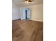 Open living area featuring hardwood floors, natural lighting, and french doors at 500 New York Ave # 21, Dunedin, FL 34698