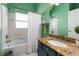 Bathroom features green paint, granite countertop vanity, and a shower-tub combo at 5001 44Th N Ave, St Petersburg, FL 33709