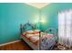 Charming bedroom with hardwood floors, bright walls, and decorative metal bed frame at 5001 44Th N Ave, St Petersburg, FL 33709