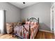Bedroom showcasing hardwood floors, neutral paint and a wrought iron bed frame at 5001 44Th N Ave, St Petersburg, FL 33709