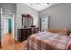 This bedroom has hardwood floors, gray paint and a vintage dresser with mirror at 5001 44Th N Ave, St Petersburg, FL 33709