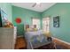 Stylish bedroom features hardwood floors, light green walls, a full size bed and dresser at 5001 44Th N Ave, St Petersburg, FL 33709