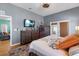 Bedroom featuring hardwood floors, decorative dresser, television, and access to the outside patio at 5001 44Th N Ave, St Petersburg, FL 33709