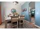 Dining room featuring a table with seating for four, a decorative mirror, and blue accent wall at 5001 44Th N Ave, St Petersburg, FL 33709