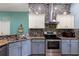 Well-equipped kitchen featuring stainless steel appliances, granite countertops, and tile backsplash at 5001 44Th N Ave, St Petersburg, FL 33709