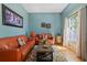 Cozy living room with comfortable leather seating, hardwood floors, and bright natural light at 5001 44Th N Ave, St Petersburg, FL 33709