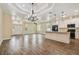 Open-concept living space featuring tile floors, high ceilings, modern lighting, and kitchen with an island at 5710 42Nd N St, St Petersburg, FL 33714
