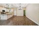 Spacious open-concept area showcasing the kitchen, dining, and living areas with wood-look floors and natural light at 5710 42Nd N St, St Petersburg, FL 33714