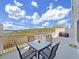 Expansive balcony with comfortable seating and a dining table overlooking serene views of nature and water at 6495 Shoreline Dr # 8105, Seminole, FL 33708