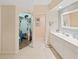 Bright bathroom featuring a walk-in closet, large vanity and tile flooring at 6495 Shoreline Dr # 8105, Seminole, FL 33708