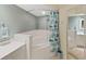 Bathroom featuring a garden tub with shower and tile surround, along with a large vanity at 6495 Shoreline Dr # 8105, Seminole, FL 33708