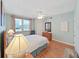Cozy bedroom with wood floors, ceiling fan, and windows offering natural light at 6495 Shoreline Dr # 8105, Seminole, FL 33708