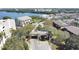 Aerial view of the community entrance with manicured landscaping, security gate, and palm trees at 6495 Shoreline Dr # 8105, Seminole, FL 33708