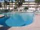 Relaxing community pool with inviting clear water, surrounded by lounge chairs and tables at 6495 Shoreline Dr # 8105, Seminole, FL 33708