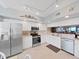 Bright and clean condo kitchen equipped with stainless steel appliances and classic white cabinets at 6495 Shoreline Dr # 8105, Seminole, FL 33708