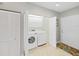 Convenient laundry room with washer, dryer, storage cabinets, and easy access to the home's interior at 6495 Shoreline Dr # 8105, Seminole, FL 33708