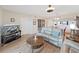 Well-lit living room offers comfortable seating, modern TV, and seamless access to other areas of the home at 6495 Shoreline Dr # 8105, Seminole, FL 33708