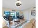 Bright living room offers plush seating, a modern TV, and access to a scenic outdoor terrace at 6495 Shoreline Dr # 8105, Seminole, FL 33708