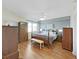 Well-lit main bedroom featuring hardwood floors, ample storage, and a cozy king-size bed at 6495 Shoreline Dr # 8105, Seminole, FL 33708