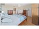 Comfortable main bedroom with wood flooring, featuring ample closet space, a king-size bed, and ensuite at 6495 Shoreline Dr # 8105, Seminole, FL 33708