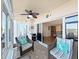 Inviting sunroom with cozy seating, ceiling fan, and sliding glass doors offering a seamless transition to the outdoors at 6495 Shoreline Dr # 8105, Seminole, FL 33708