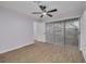 Light filled bedroom with wood-look flooring, a ceiling fan, and large sliding glass doors at 6672 56Th N Ave, St Petersburg, FL 33709
