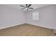 A cozy bedroom with light walls, wood flooring, a ceiling fan, and a window offering natural light at 6672 56Th N Ave, St Petersburg, FL 33709