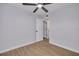 Bedroom featuring light walls, wood flooring, a ceiling fan and door to an adjacent room at 6672 56Th N Ave, St Petersburg, FL 33709